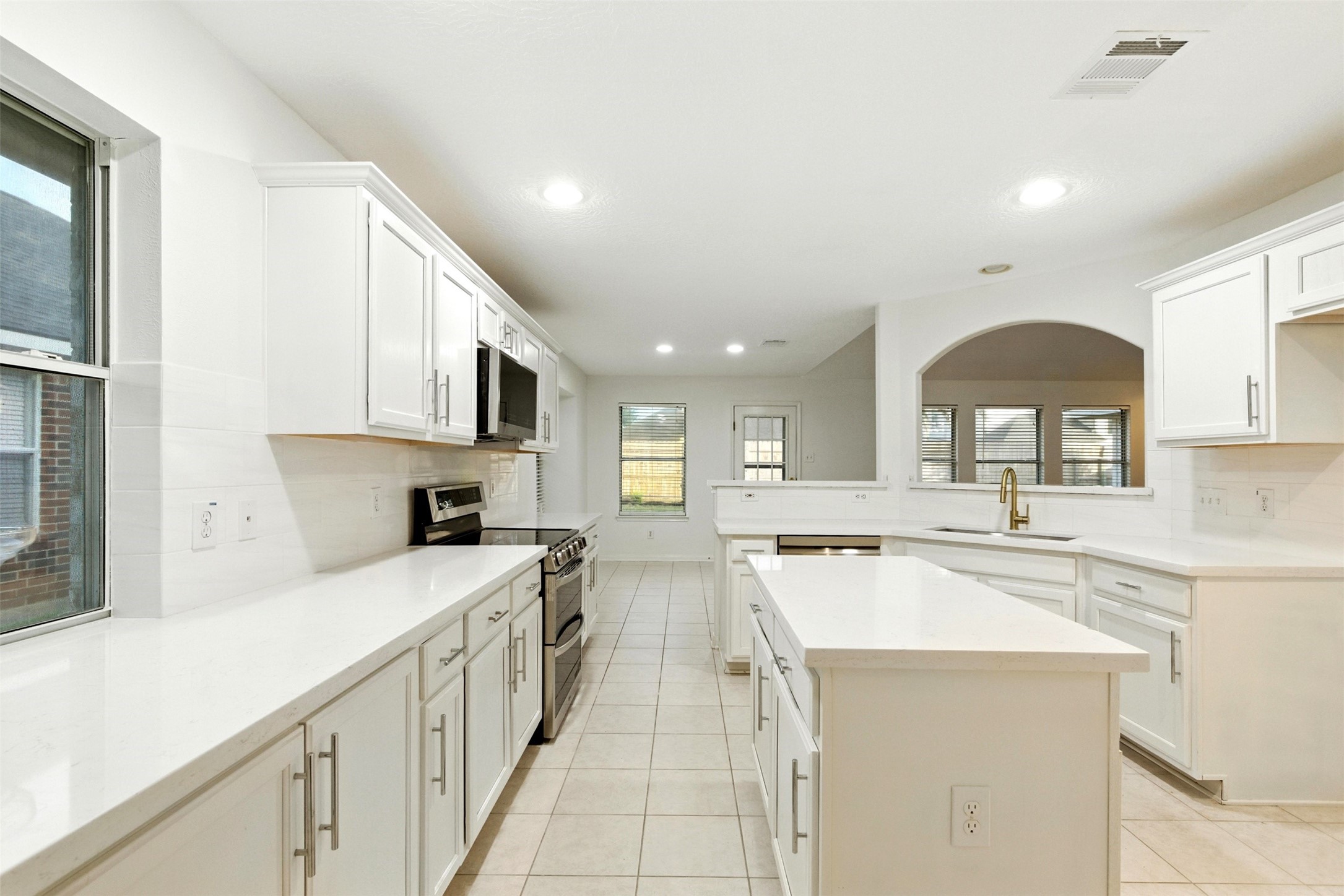 2119 Hannover Way Spring, TX 77388 - Photo 14 of 39 a kitchen with a sink stove top oven and cabinets