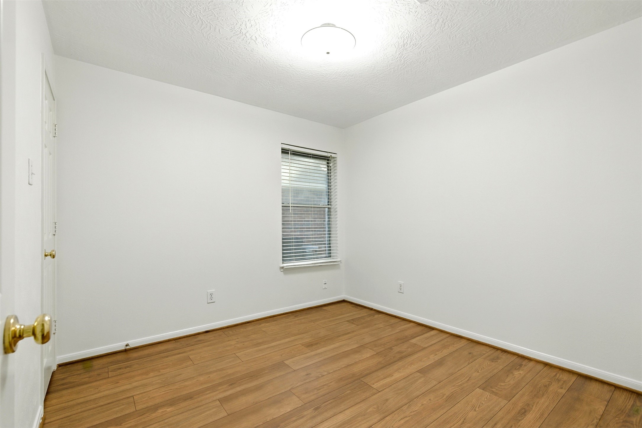 2119 Hannover Way Spring, TX 77388 - Photo 24 of 39 an empty room with wooden floor and windows