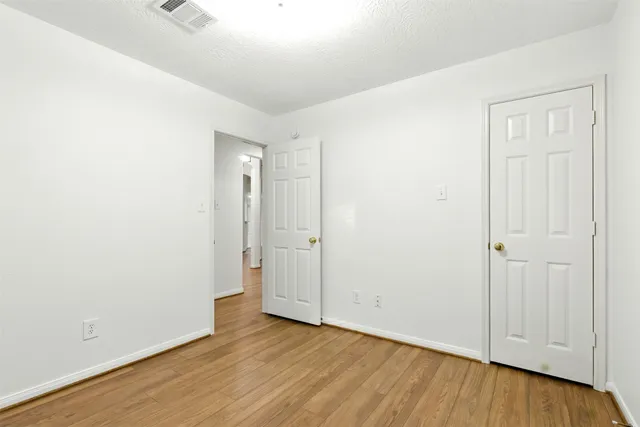 an empty room with wooden floor