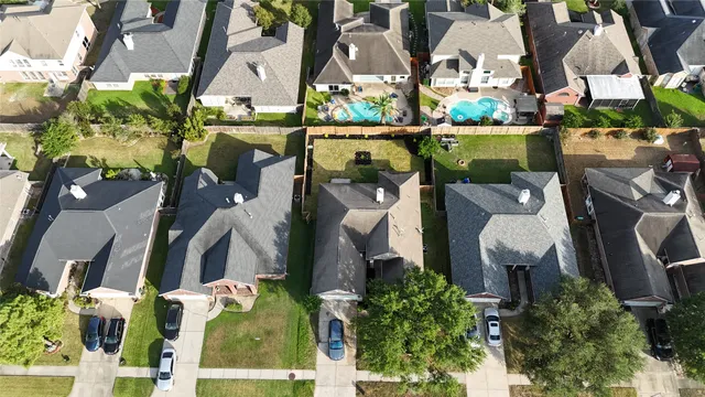 an aerial view of houses with yard