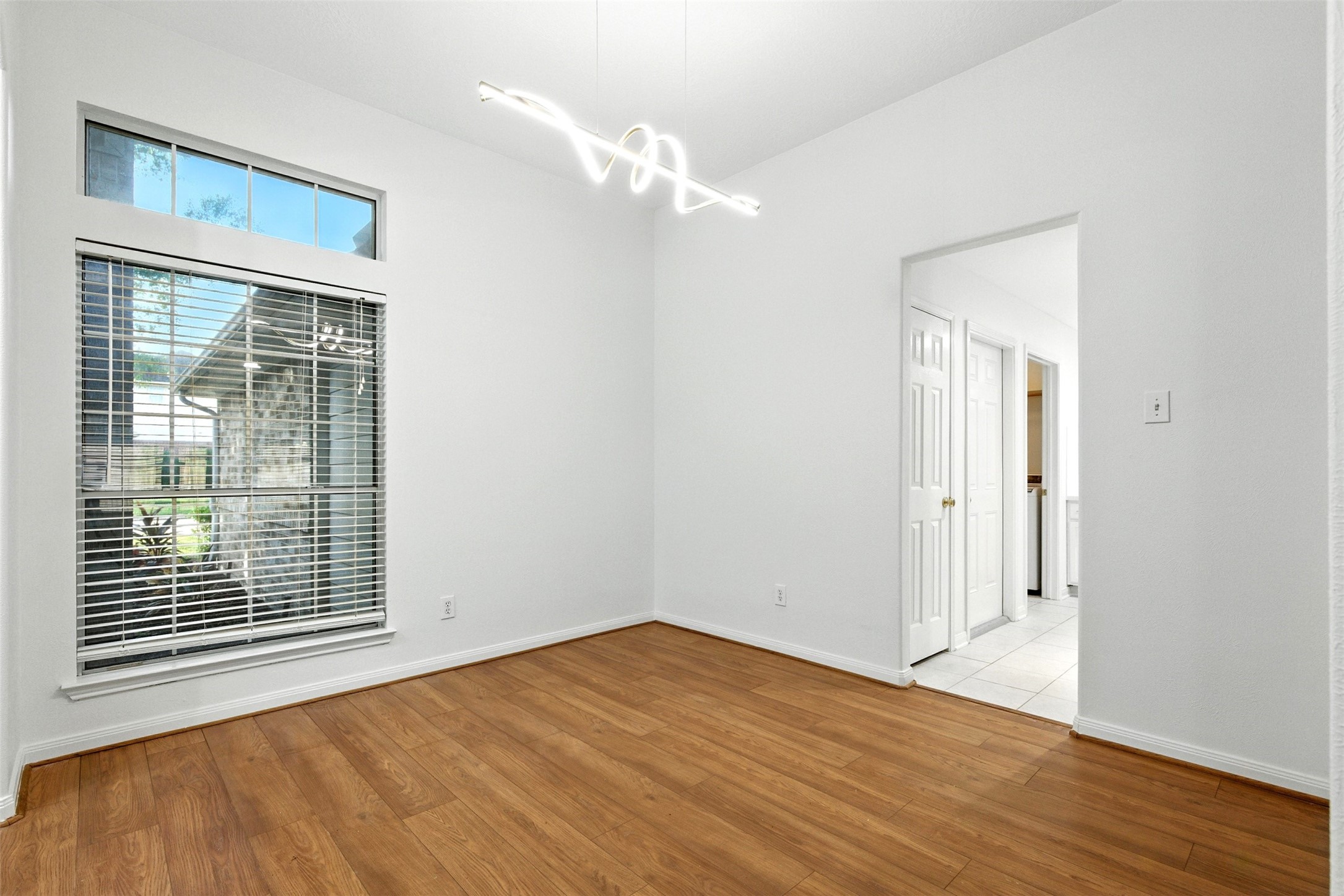 2119 Hannover Way Spring, TX 77388 - Photo 6 of 39 a view of an empty room with wooden floor and a window