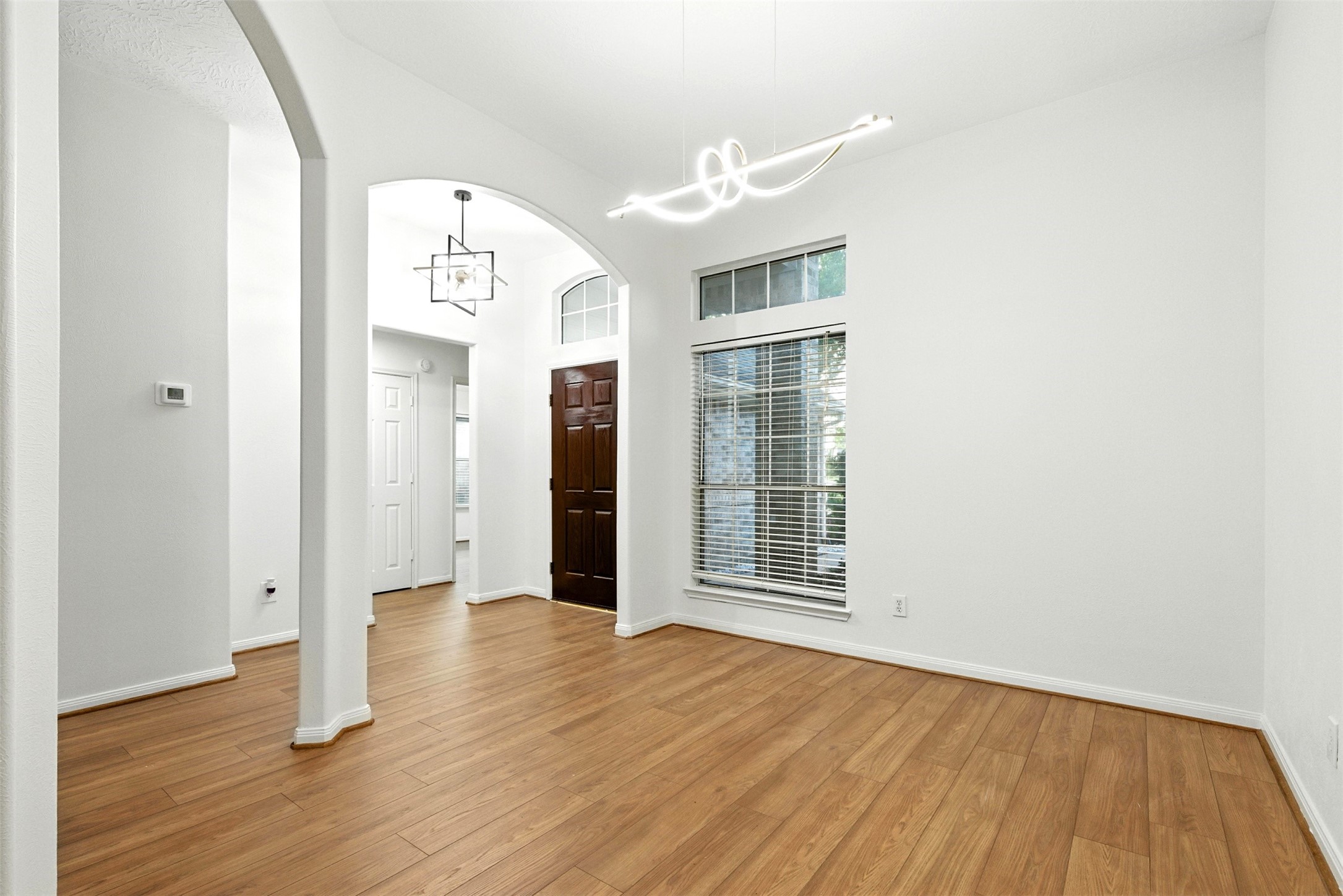 2119 Hannover Way Spring, TX 77388 - Photo 7 of 39 an empty room with wooden floor and windows