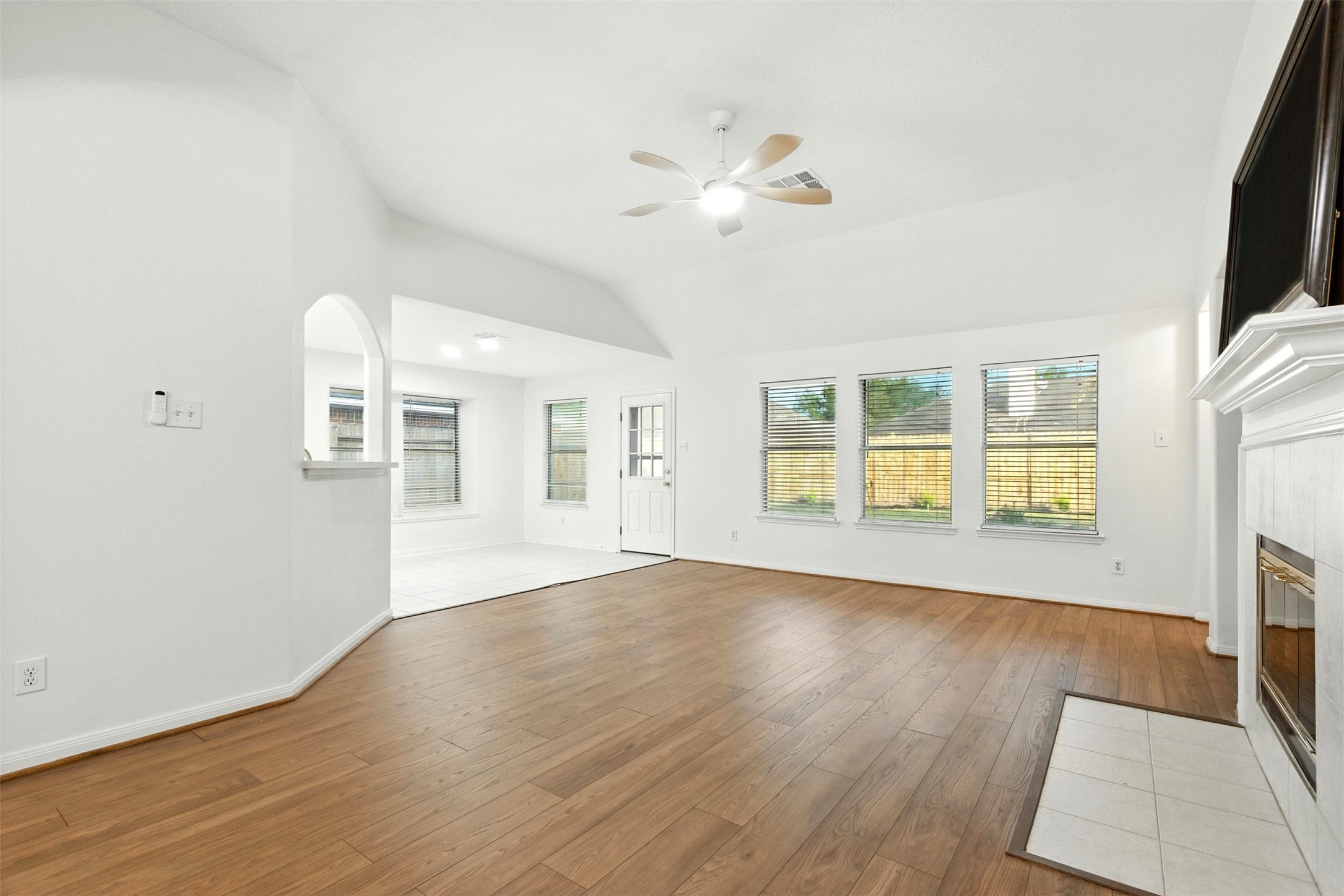 2119 Hannover Way Spring, TX 77388 - Photo 8 of 39 a view of an empty room with wooden floor and a window