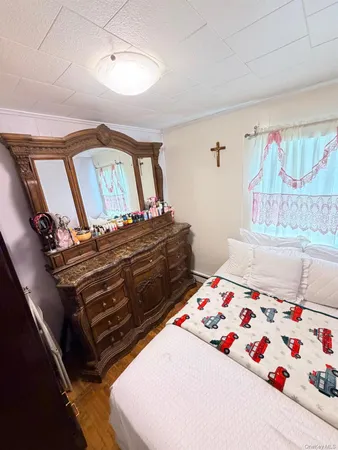 a bed sitting in a bedroom next to a window