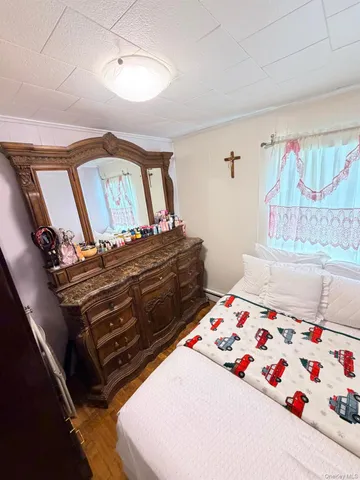 a bed sitting in a bedroom next to a window