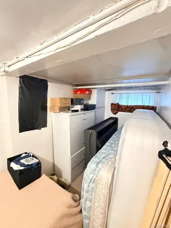 a bedroom with a bed and a night stand