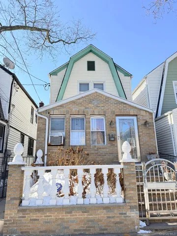 a view of a white house with large windows
