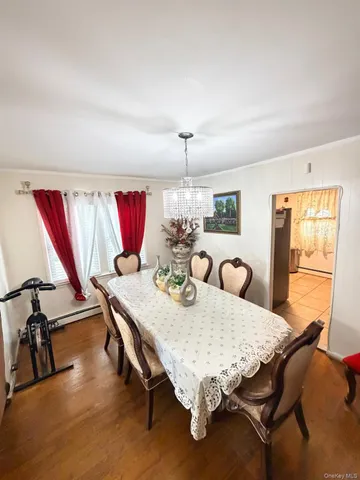 a dining room with furniture and chandelier