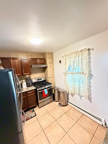 a kitchen with a refrigerator and a stove top oven
