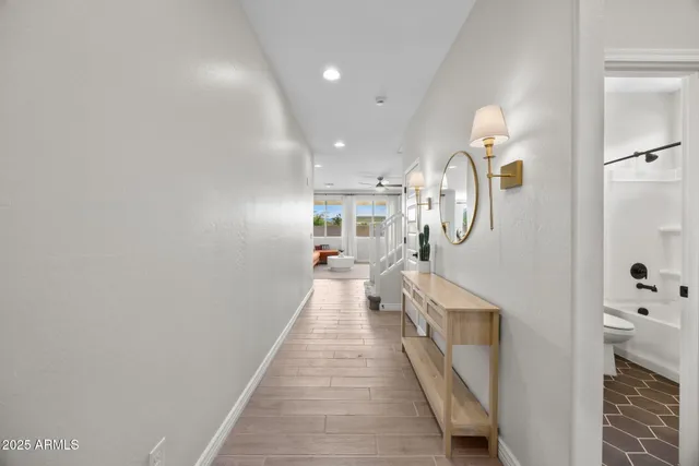 a living room with furniture and a flat screen tv with wooden floor