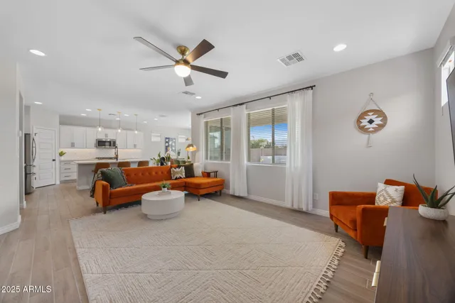 a living room with furniture and a chandelier