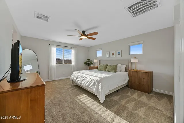 a bathroom with a double vanity sink and mirror with shower