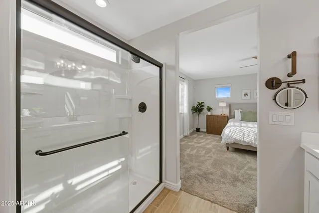 a bedroom with a bed next to a window