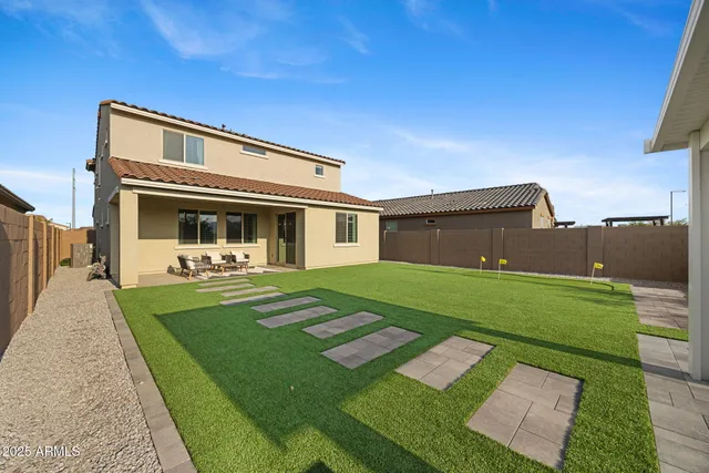 a swimming pool with outdoor seating and a garden