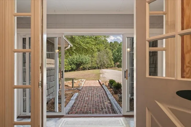 a view of empty room with window and wooden floor