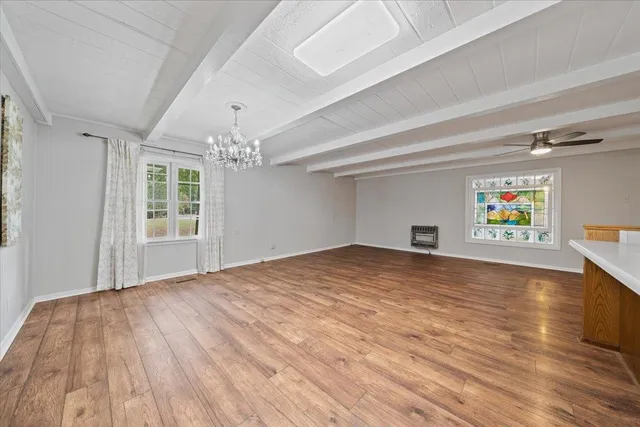 a kitchen with granite countertop a stove sink and refrigerator