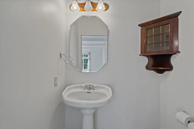 an empty room with ceiling fan and windows