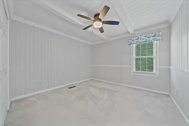a view of a livingroom with a ceiling fan and window