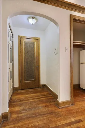 a view of a hallway with wooden floor and a hallway