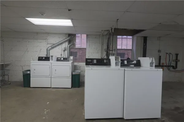 a utility room with cabinets washer and dryer
