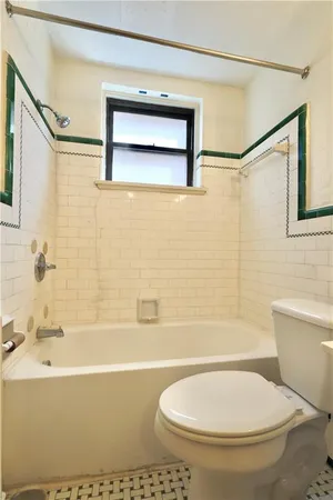 a bathroom with a toilet and a bathtub