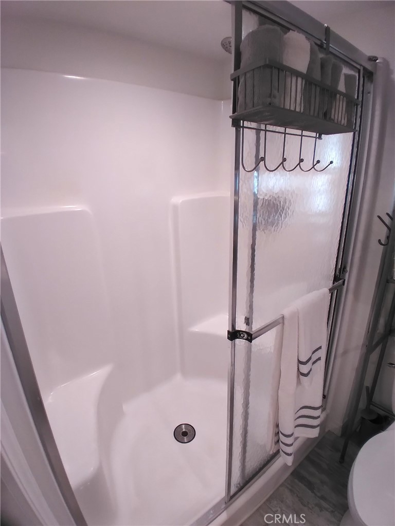 681 Channel Way Needles, CA 92363 - Photo 14 of 26 a bathroom with a glass shower door