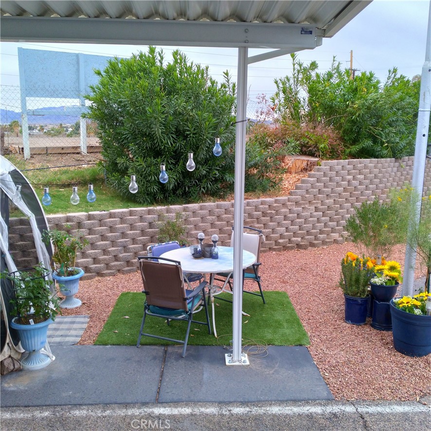 681 Channel Way Needles, CA 92363 - Photo 20 of 26 a patio with table and chairs potted plants