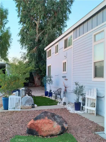 a view of a backyard with plants and outdoor seating