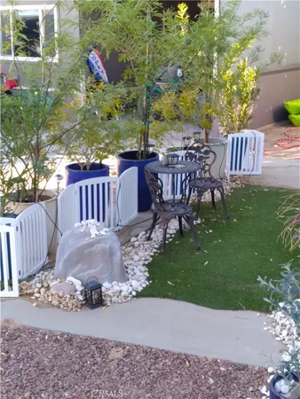 a view of a chairs and table in backyard