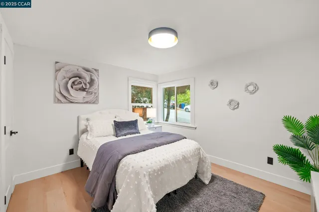 a bedroom with a bed and a potted plant