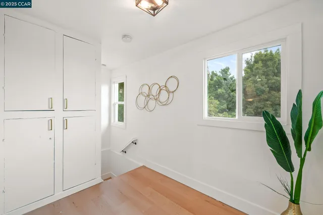 a view of entryway with a window and wooden floor