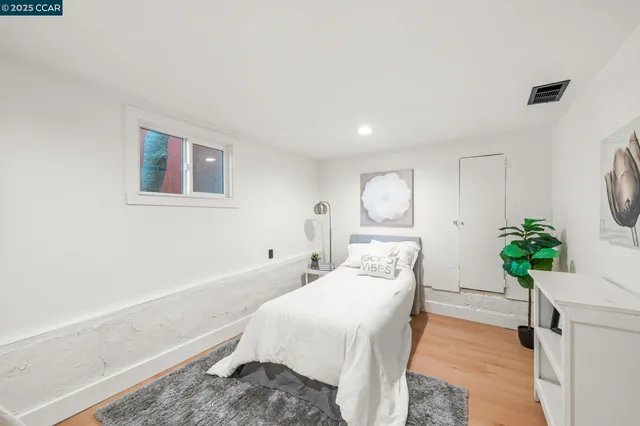 a bed room with a bed and a potted plant