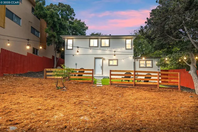a view of a chairs and tables in the back yard of the house