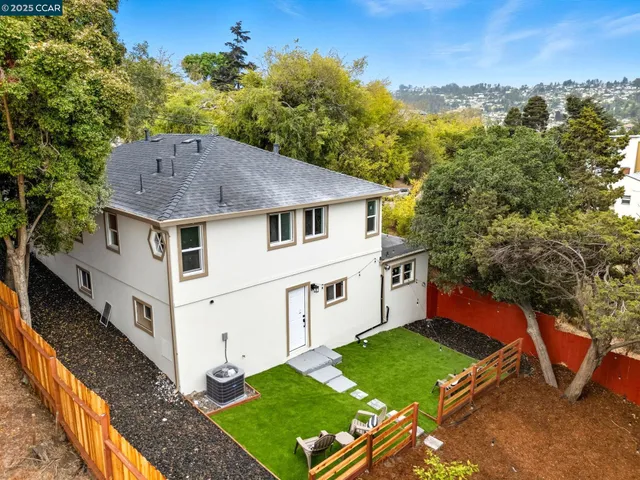 a aerial view of a house with table and chairs