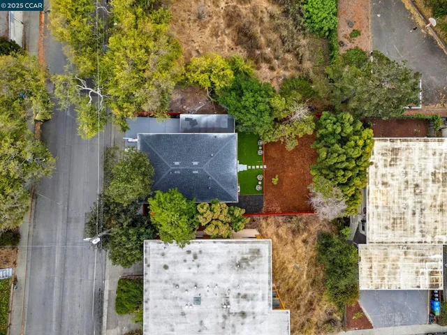 an aerial view of a house with a yard