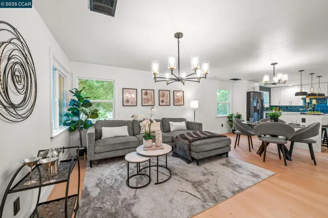 a living room with furniture a rug and white walls