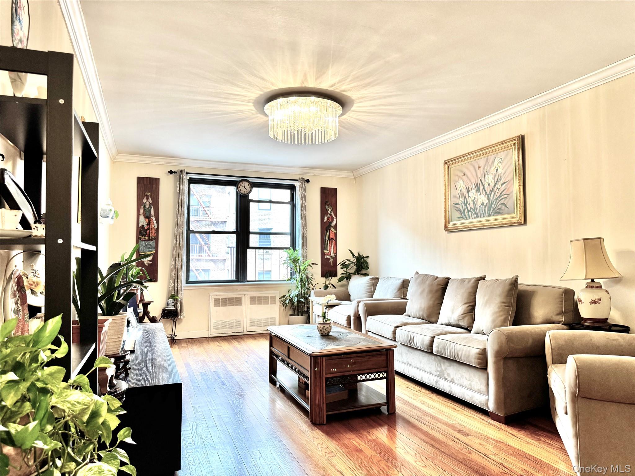 150-25 72nd Road, Unit 4C Queens, NY 11367 - Photo 4 of 16 a living room with furniture and a large window