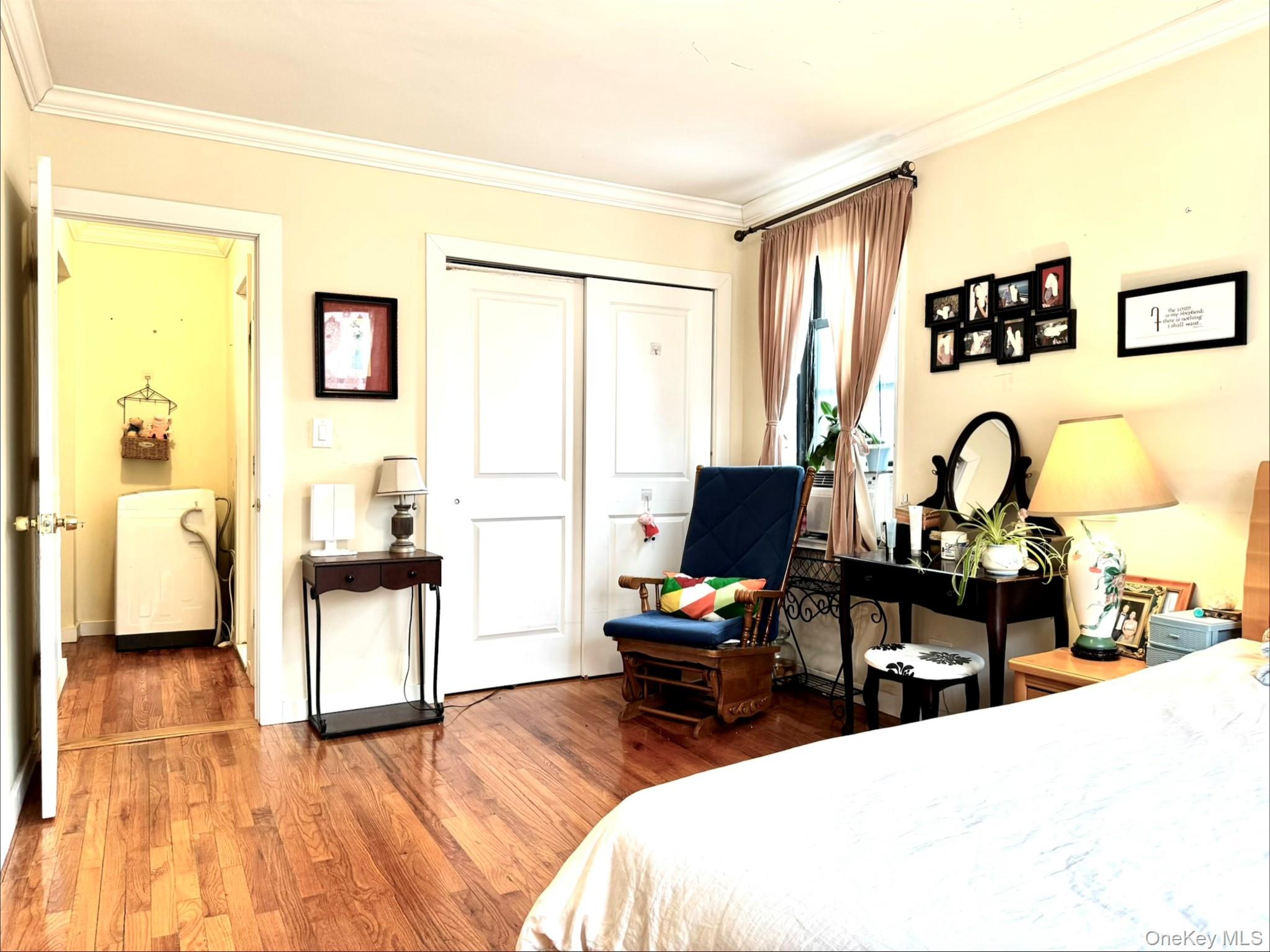 150-25 72nd Road, Unit 4C Queens, NY 11367 - Photo 7 of 16 a living room with furniture a flat screen tv and a window