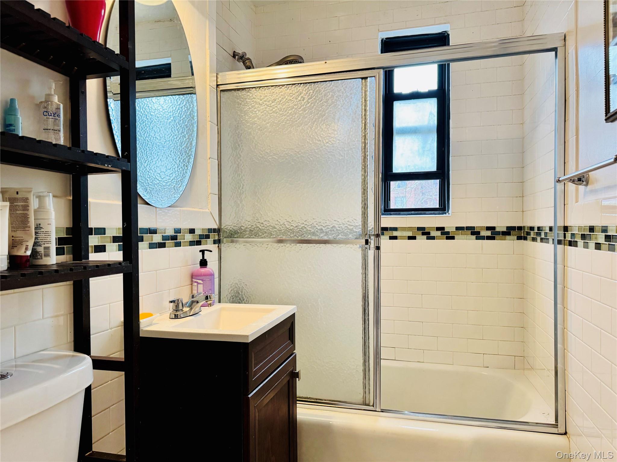 150-25 72nd Road, Unit 4C Queens, NY 11367 - Photo 8 of 16 a bathroom with a sink and mirror