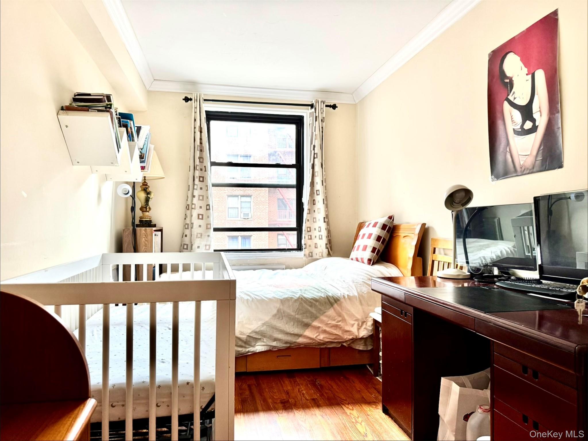 150-25 72nd Road, Unit 4C Queens, NY 11367 - Photo 9 of 16 a bedroom with a bed and a window