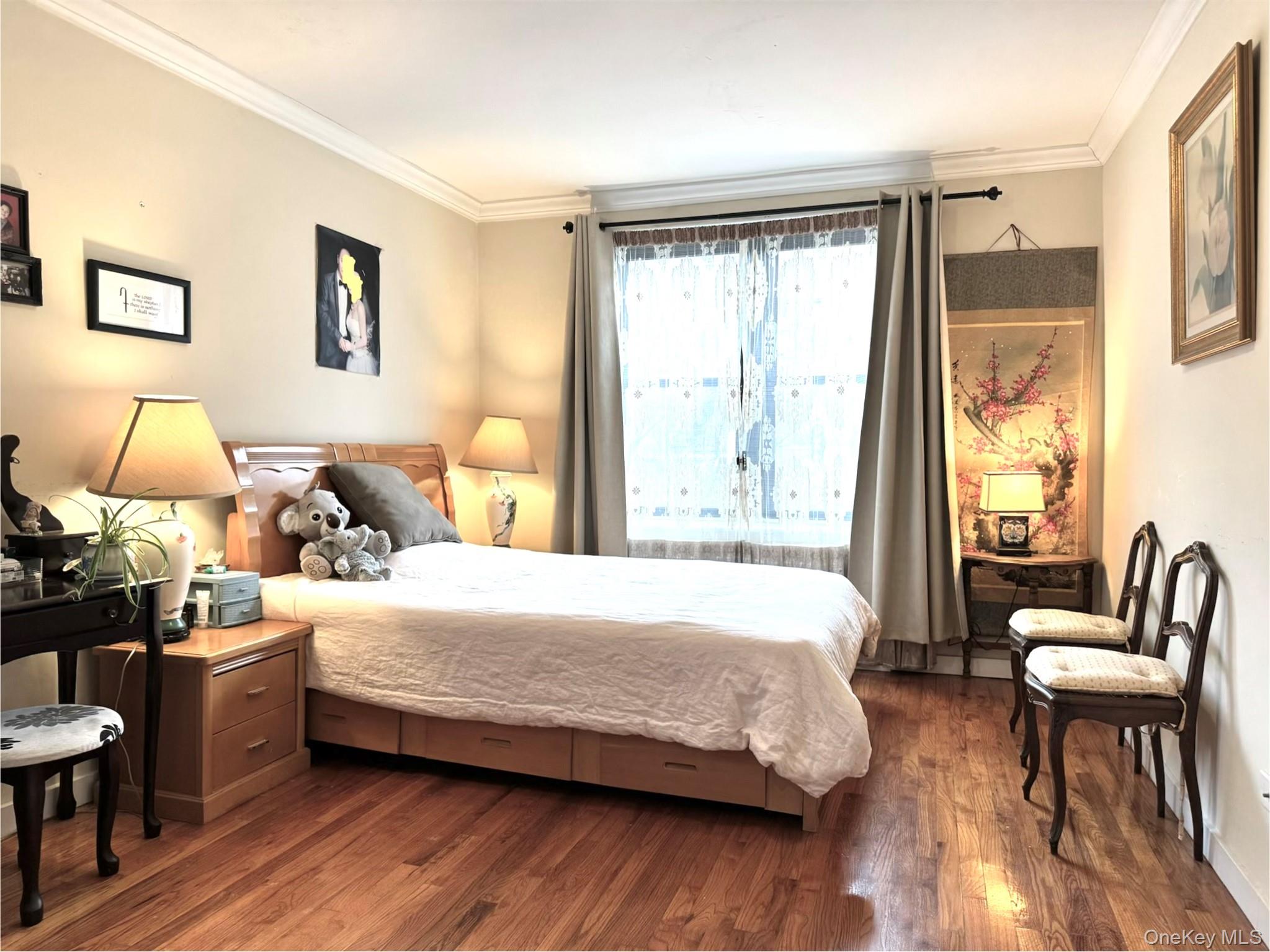 150-25 72nd Road, Unit 4C Queens, NY 11367 - Photo 10 of 16 a bedroom with a bed and wooden floor