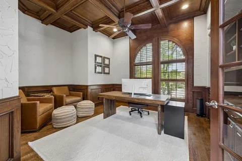 a living room with furniture a flat screen tv and a window