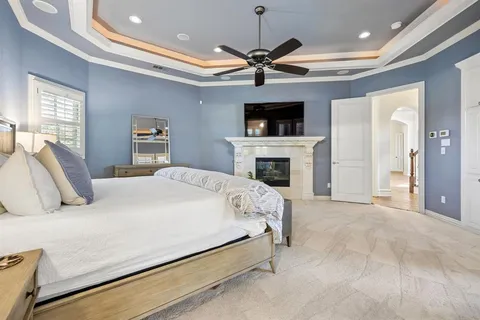 a bedroom with a large bed and a flat screen tv