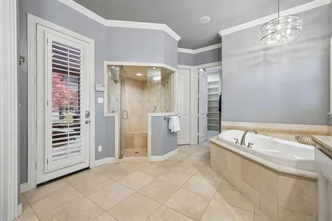 a spacious bathroom with a tub shower and sink