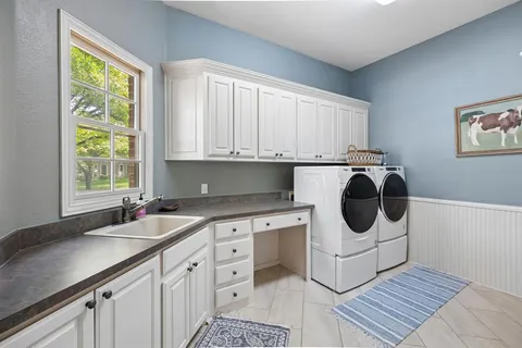 a kitchen with a sink a stove a microwave and cabinets