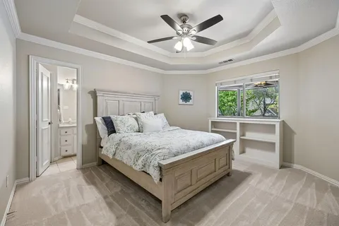a bedroom with a large bed and a window