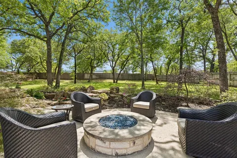 a view of a patio with couches chairs and a fire pit