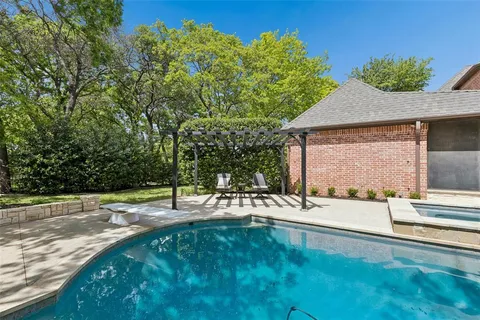 a swimming pool with outdoor seating and yard