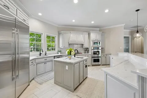 a kitchen with a stove a refrigerator and a sink