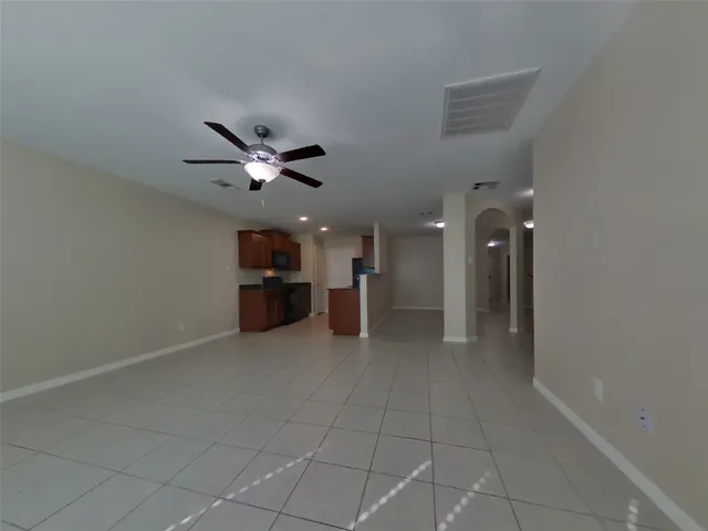 a view of a livingroom with a ceiling fan and window